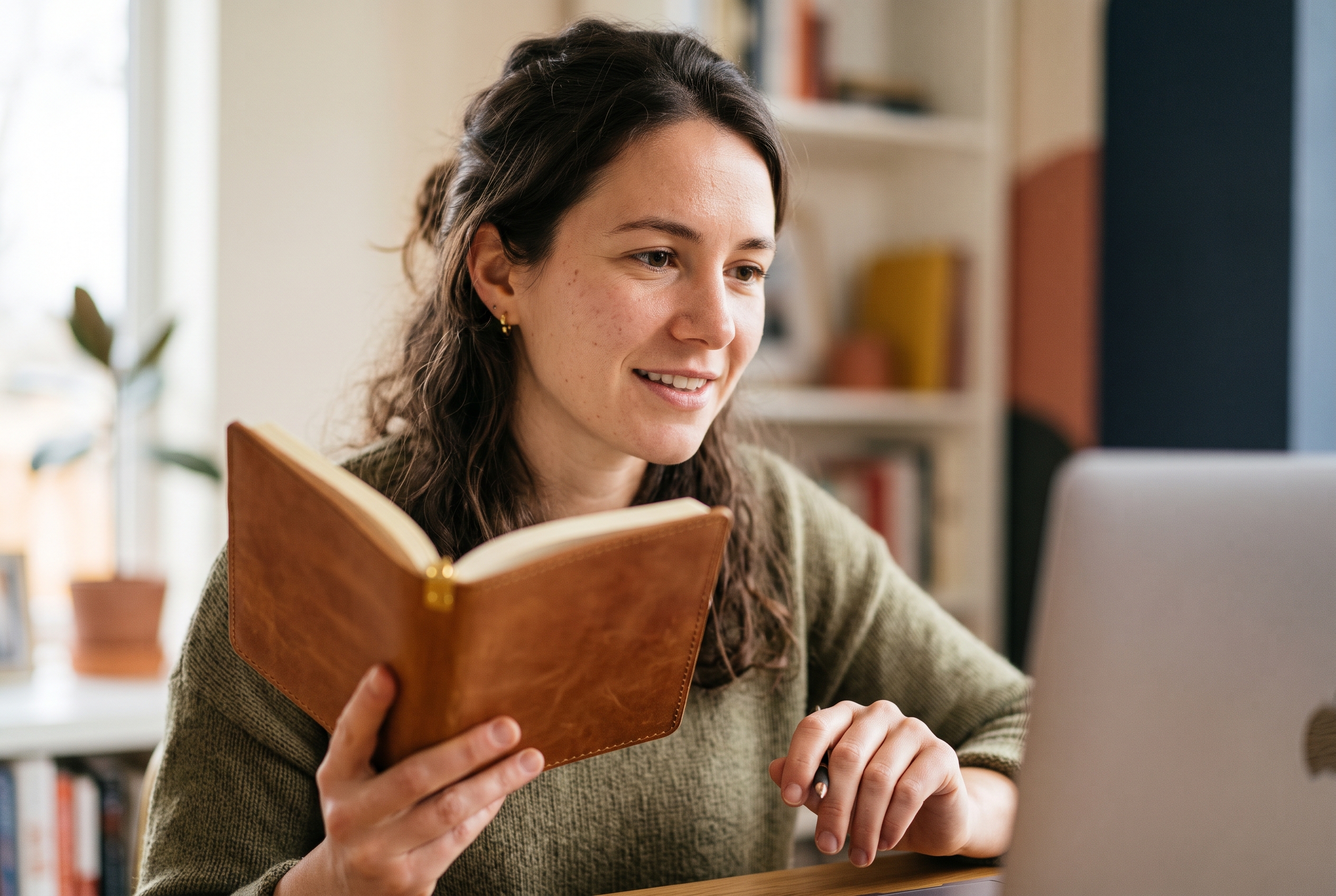 Merchant on a video call with a supplier while holding a product sample in a bright home office